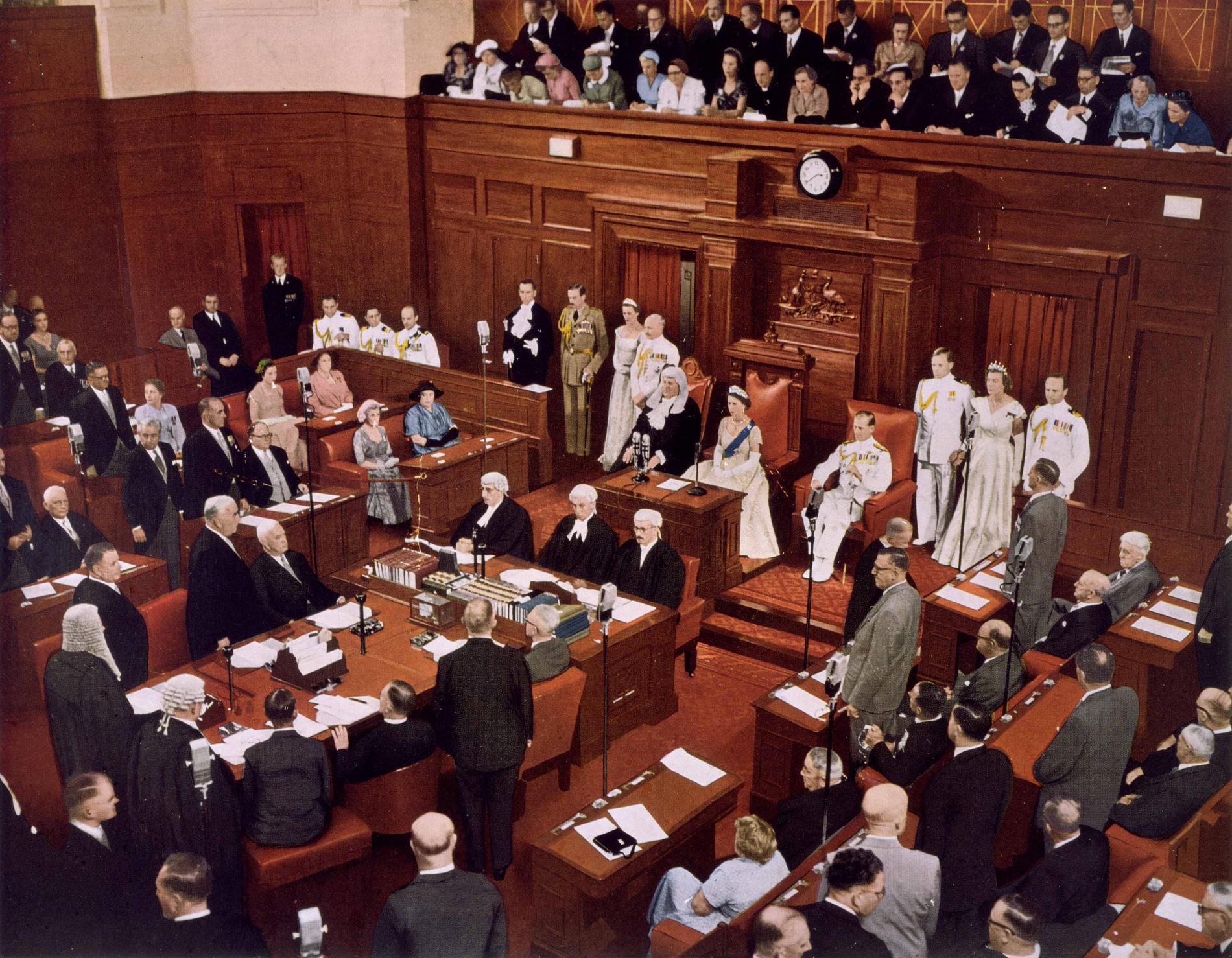 The Senate Chamber filled with people as Queen Elizabeth sits in a chair, opening the third session of the 20th federal parliament.