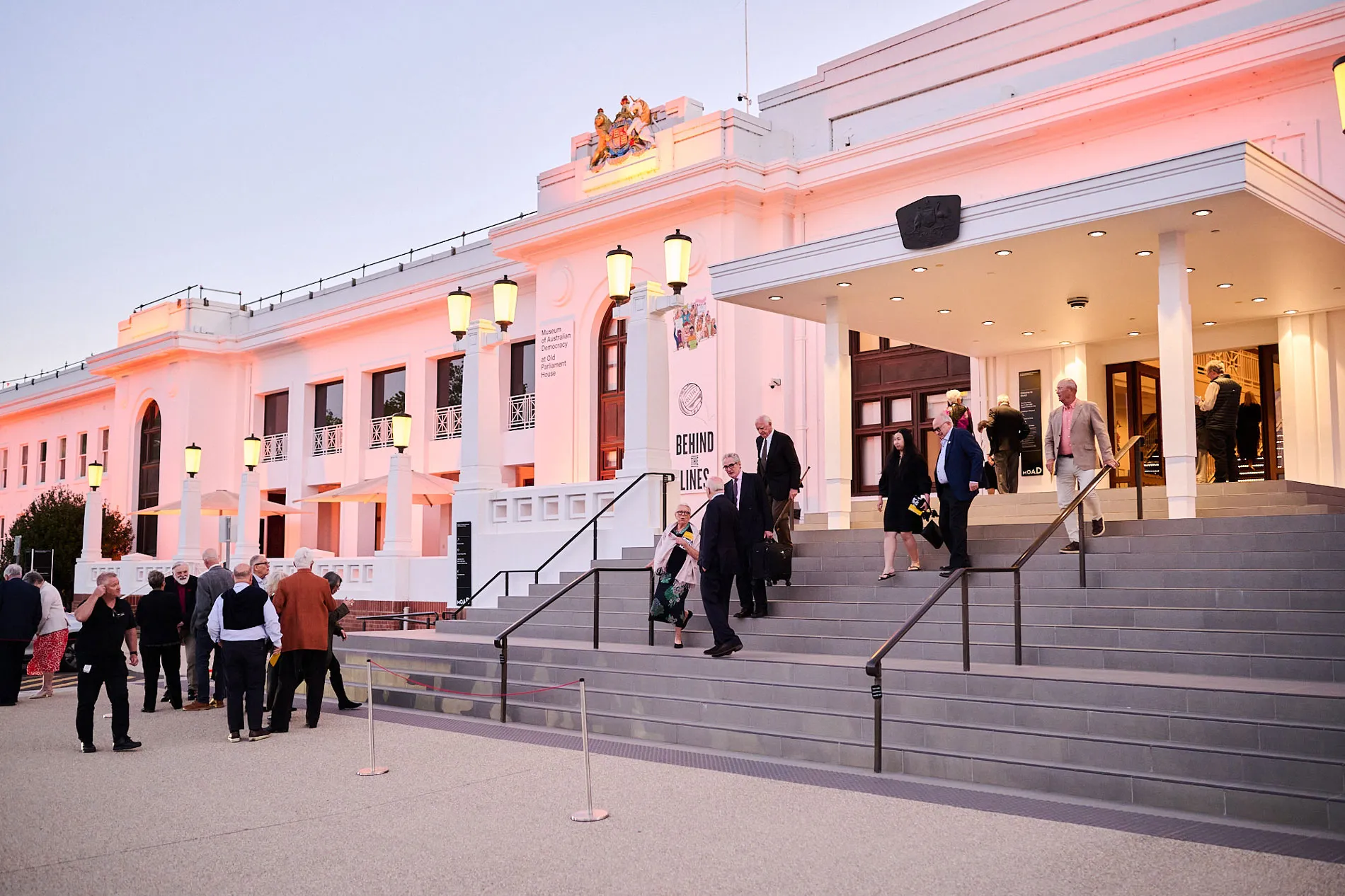 People on the front steps of the Museum of Australian Democracy at Old Parliament House for the beginning of the events for the 50th anniversary of the Whitlam dismissal.