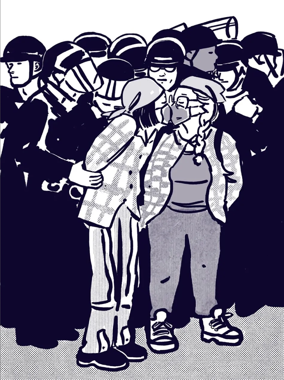 Against a backdrop of police in riot gear, two protestors in medical masks kiss. 