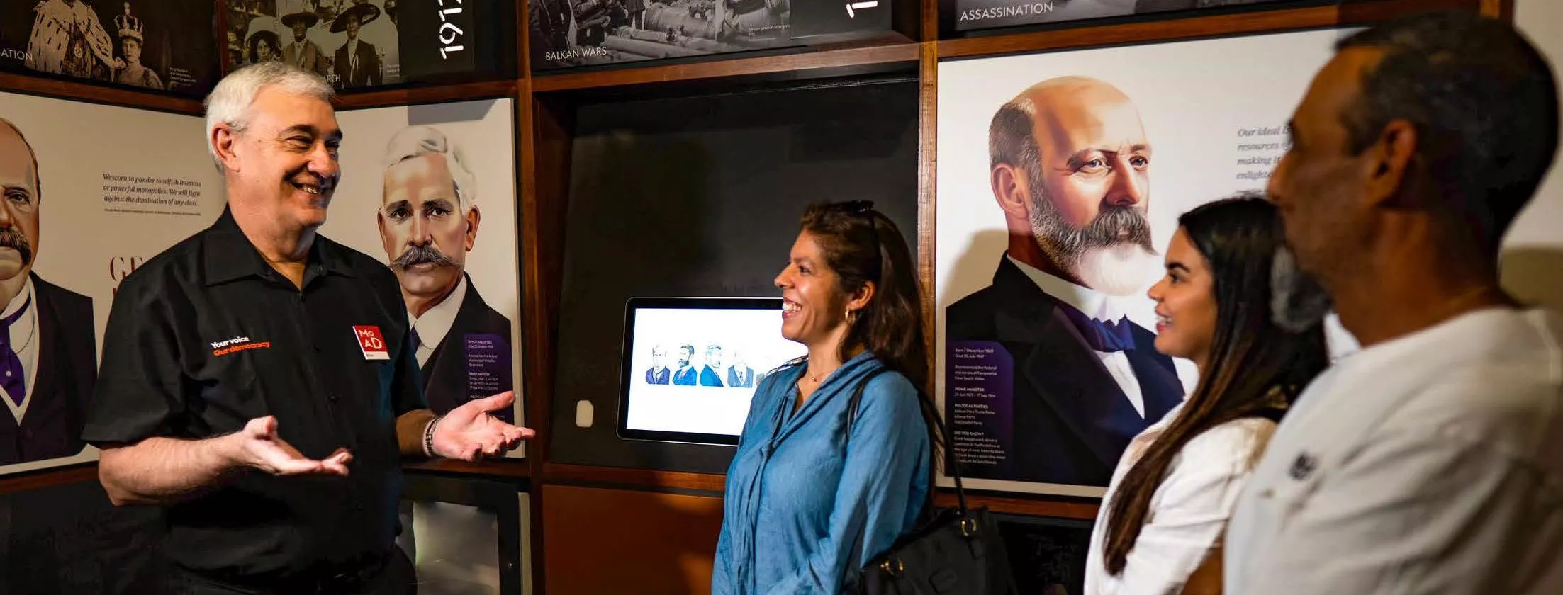 A tour guide talking to visitors to the museum