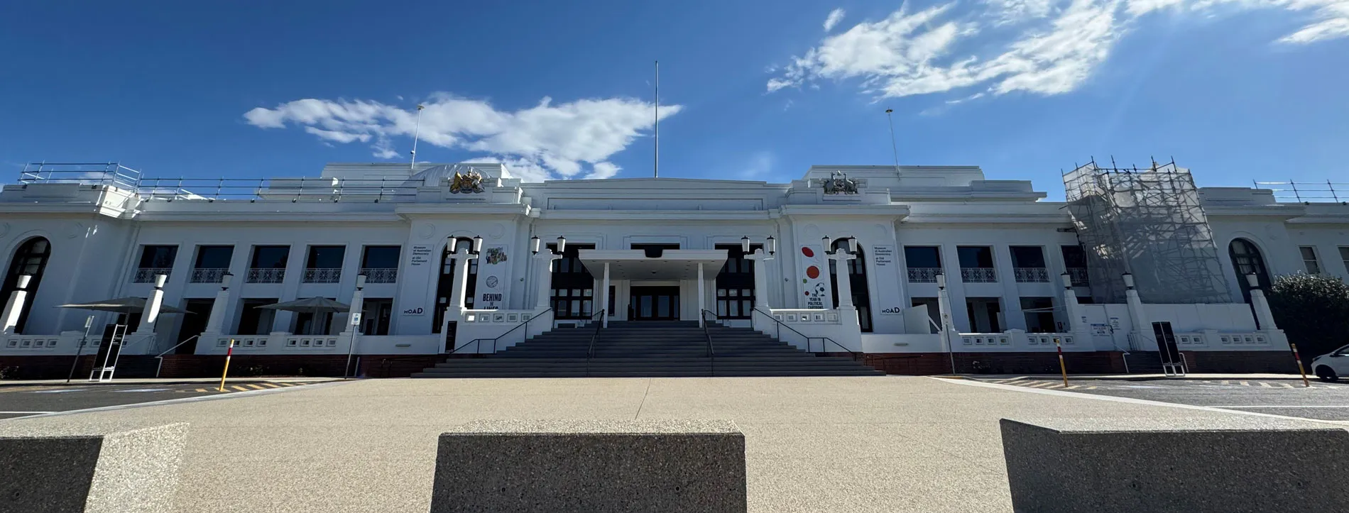 The front of Old Parliament House in Canberra with scaffolding on the right of the buildling.