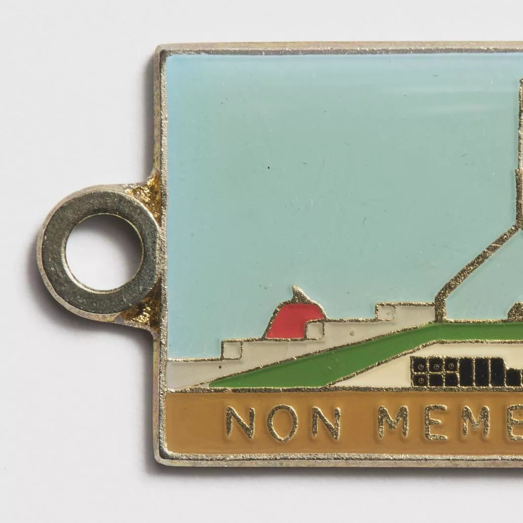 Photograph of a metal tag labled "Non members bar"