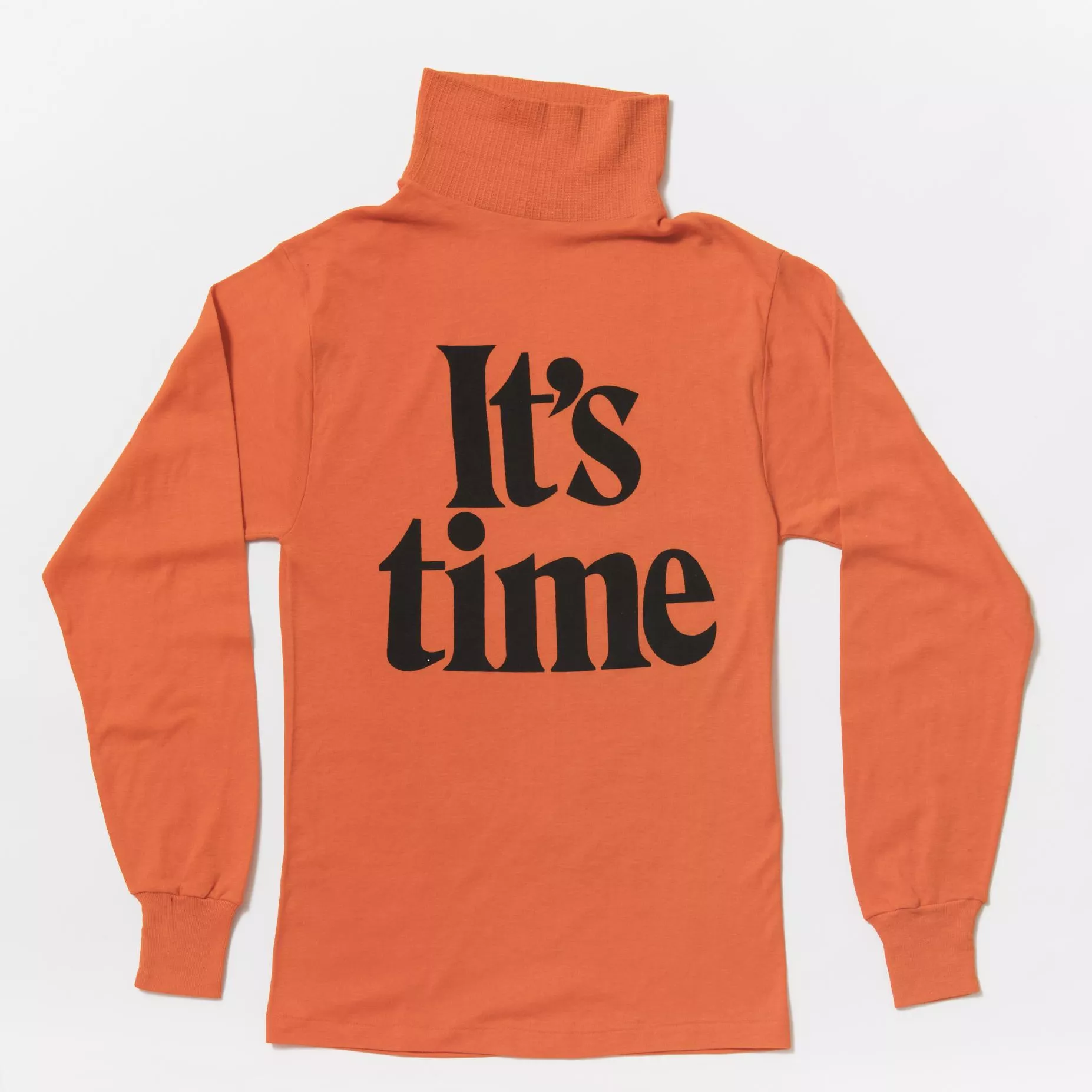 A bright orange long-sleeved skivvy with the words 'It's time' in big black font on the front.