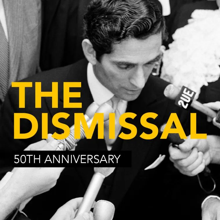 Many hands hold microphones toward David Smith's face as he reads the proclamation dissolving parliament. The words 'The Dismissal 50th Anniversary' appear over the top of the image.