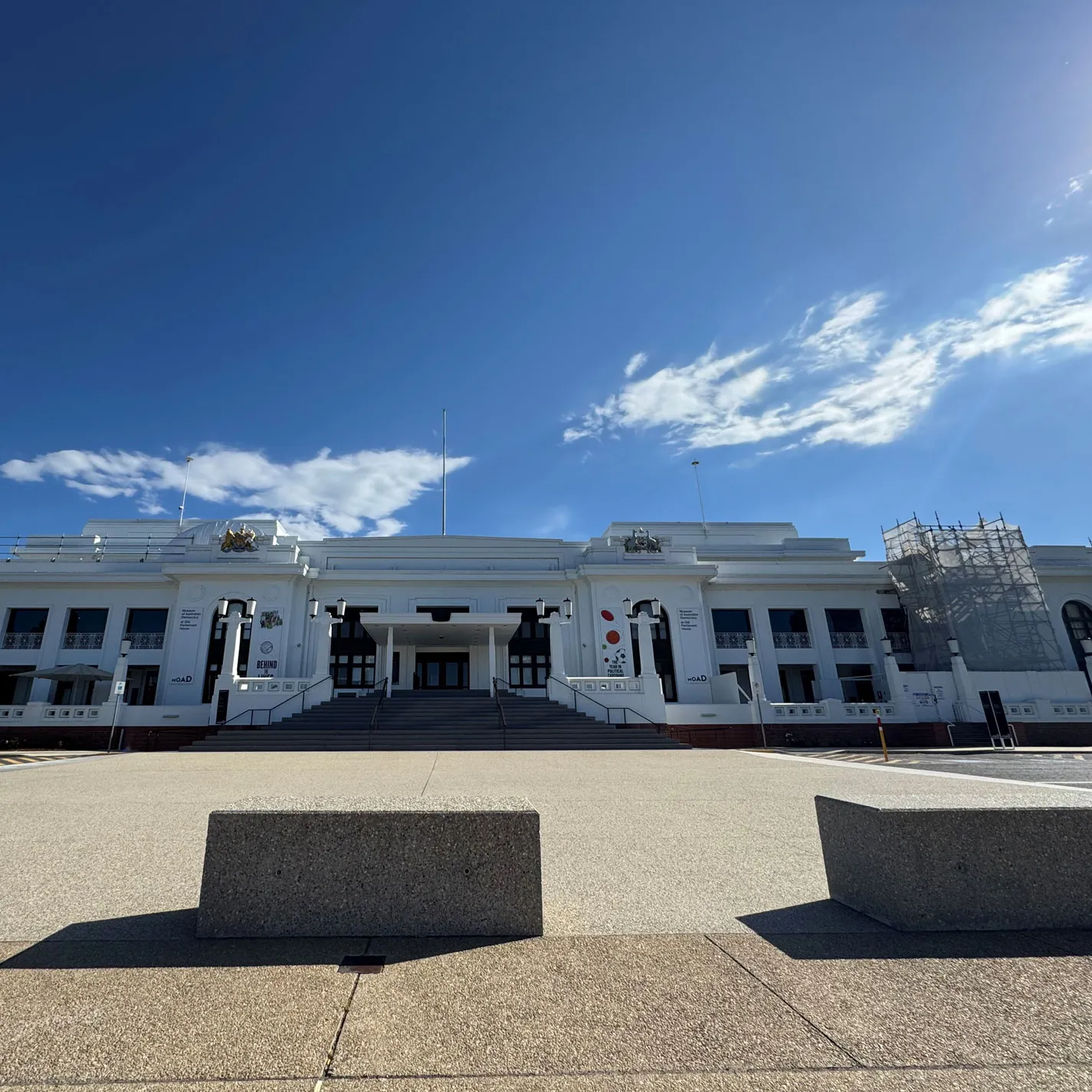 The front of Old Parliament House in Canberra with scaffolding on the right of the buildling.