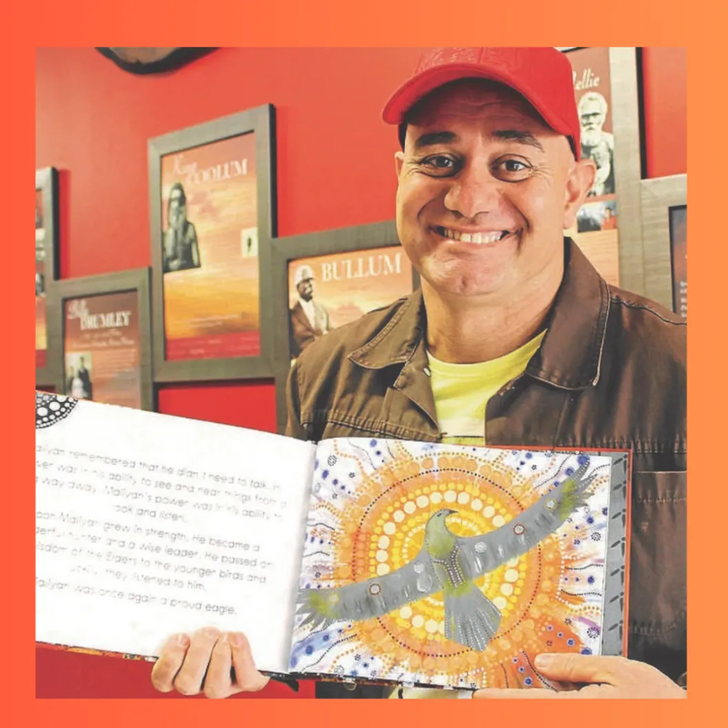 Gregg Dreise standing with his book "One Race"