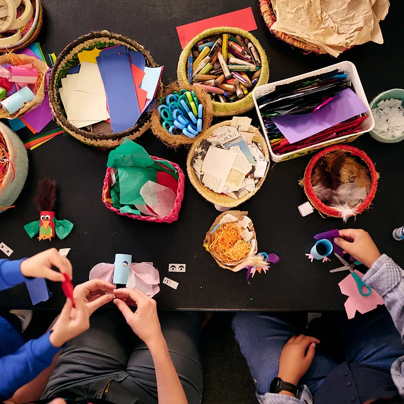 Kids and adults craft at a crafting table at Old Parliament House.