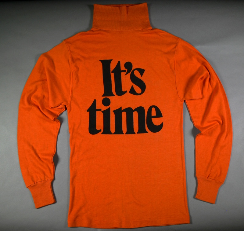 An orange skivvy with the words 'It's time' in bold black letters.