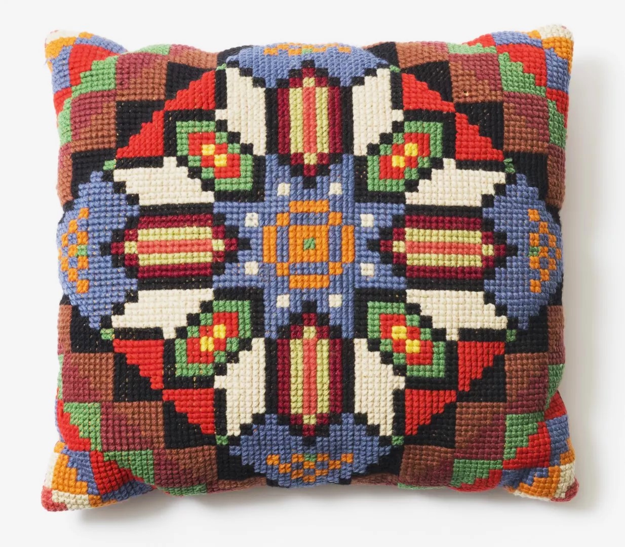 An embroidered multicoloured knitted cushion.