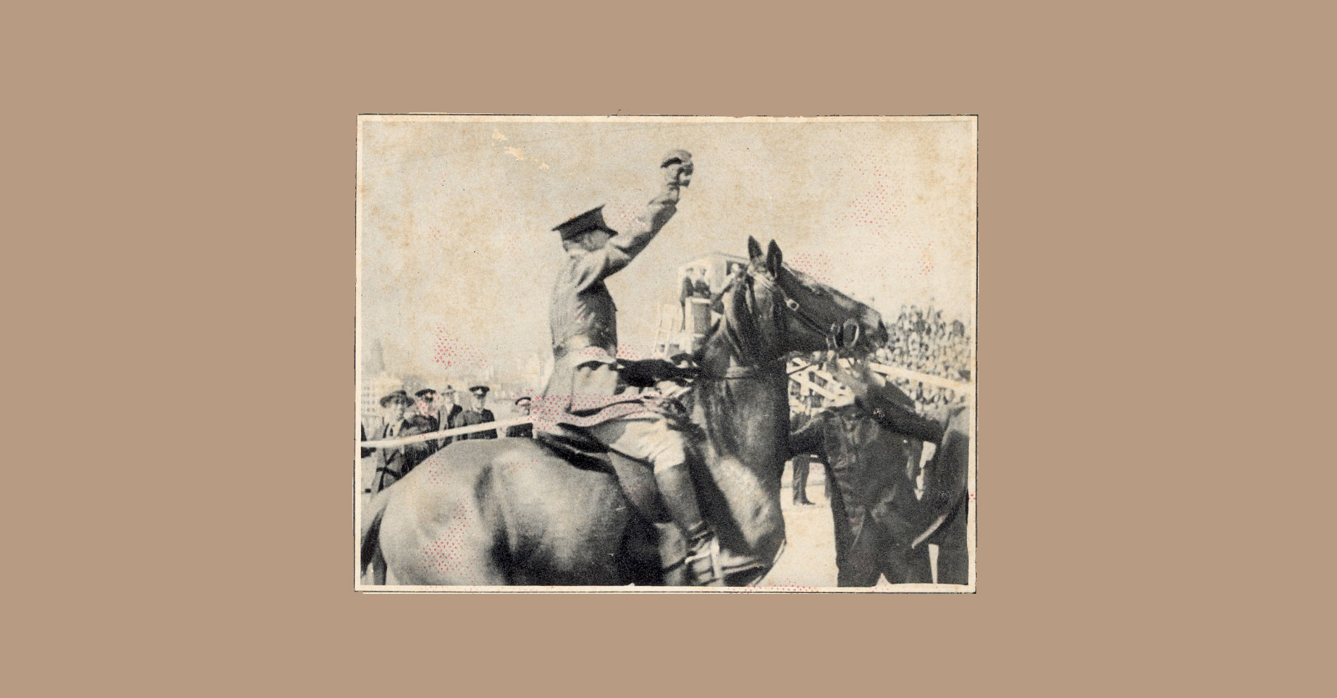 Black and white published photo of Francis de Groot, in uniform, sitting on a horse, sword raised, surrounded by people.