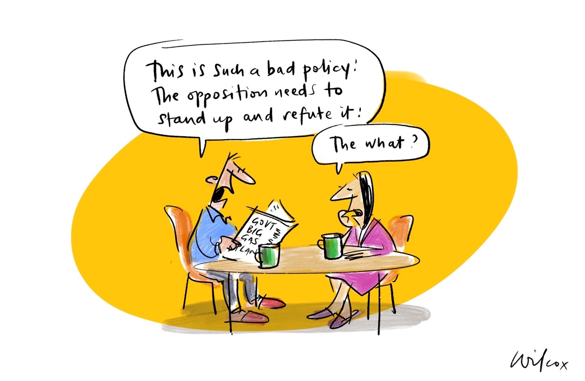 Two people sit at a table with mugs in front of them. One, reading a newspaper, says 'This is such a bad policy. The opposition needs to stand up and refute it'. The other responds, 'The what?'