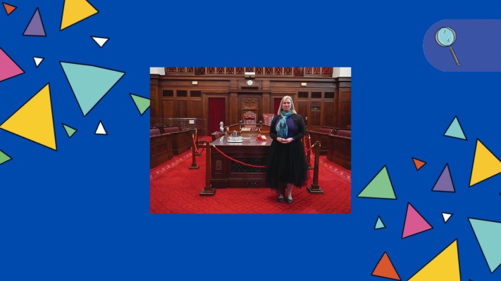 A woman stands in the Senate Chamber at Old Parliament House.