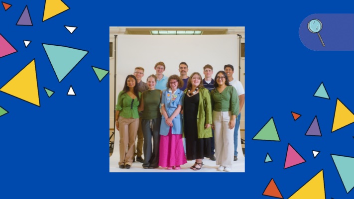 A group of students stands in front of a white background in King's Hall, Old Parliament House.