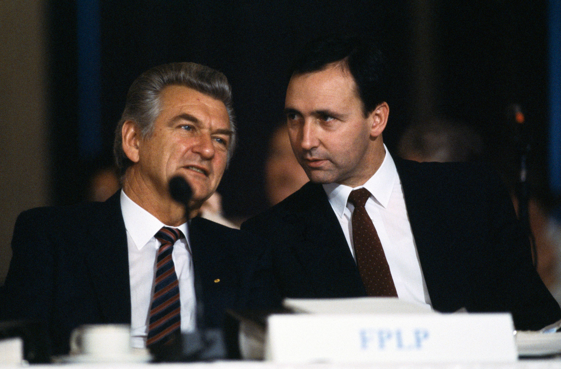 Prime Minister Bob Hawke and (future prime minister) Paul Keating sit behind a microphone at an Australian Labor Party conference.