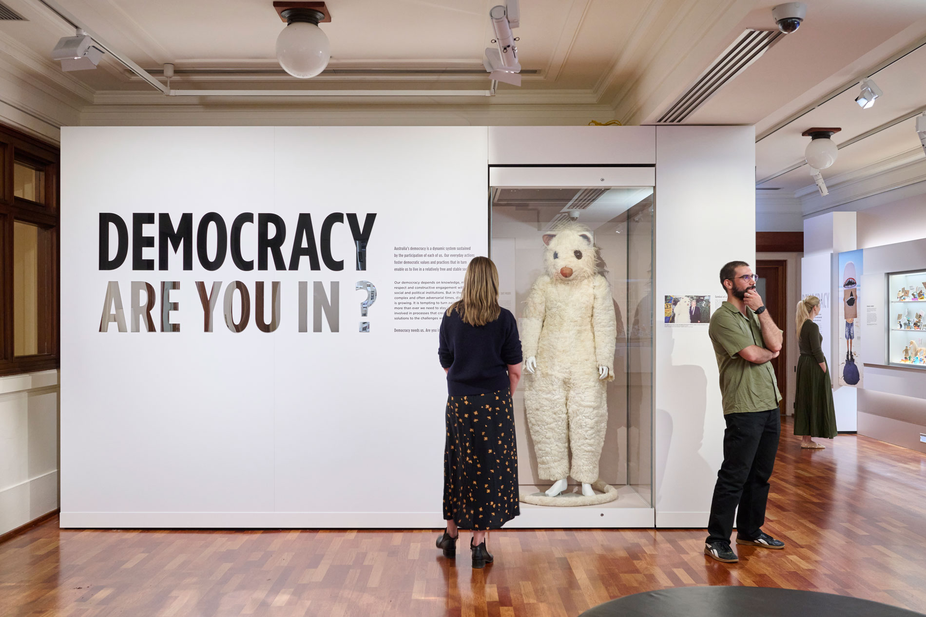 People view the Democracy Are You In exhibition featuring a giant possum costume in Old Parliament House.
