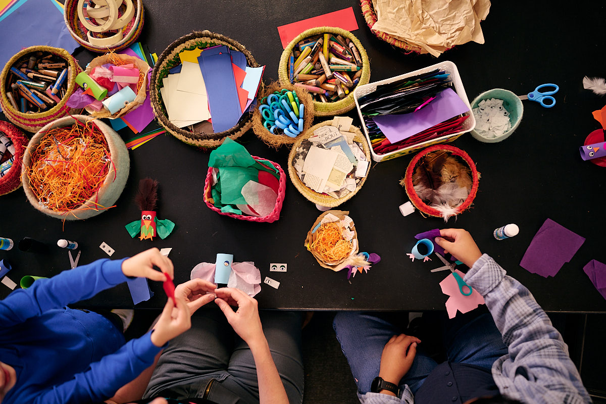 Kids and adults craft at a crafting table at Old Parliament House.