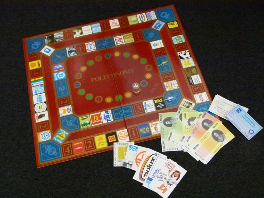 A brown coloured board game entitled 'Poleconomy', with paper money and cards with local business logos.