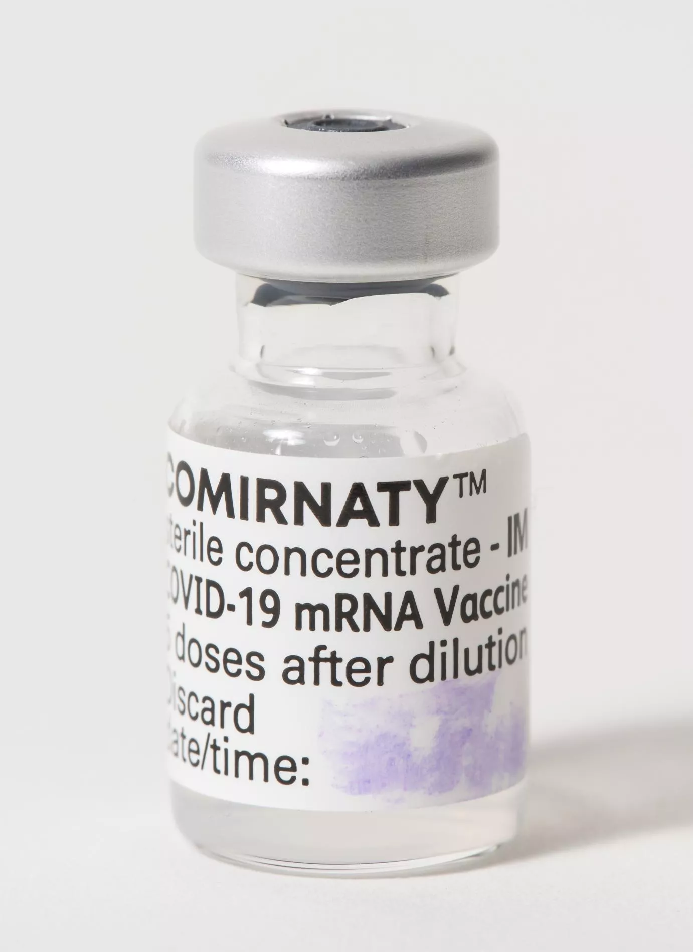 A vaccination vial with a label with the words Comirnaty.