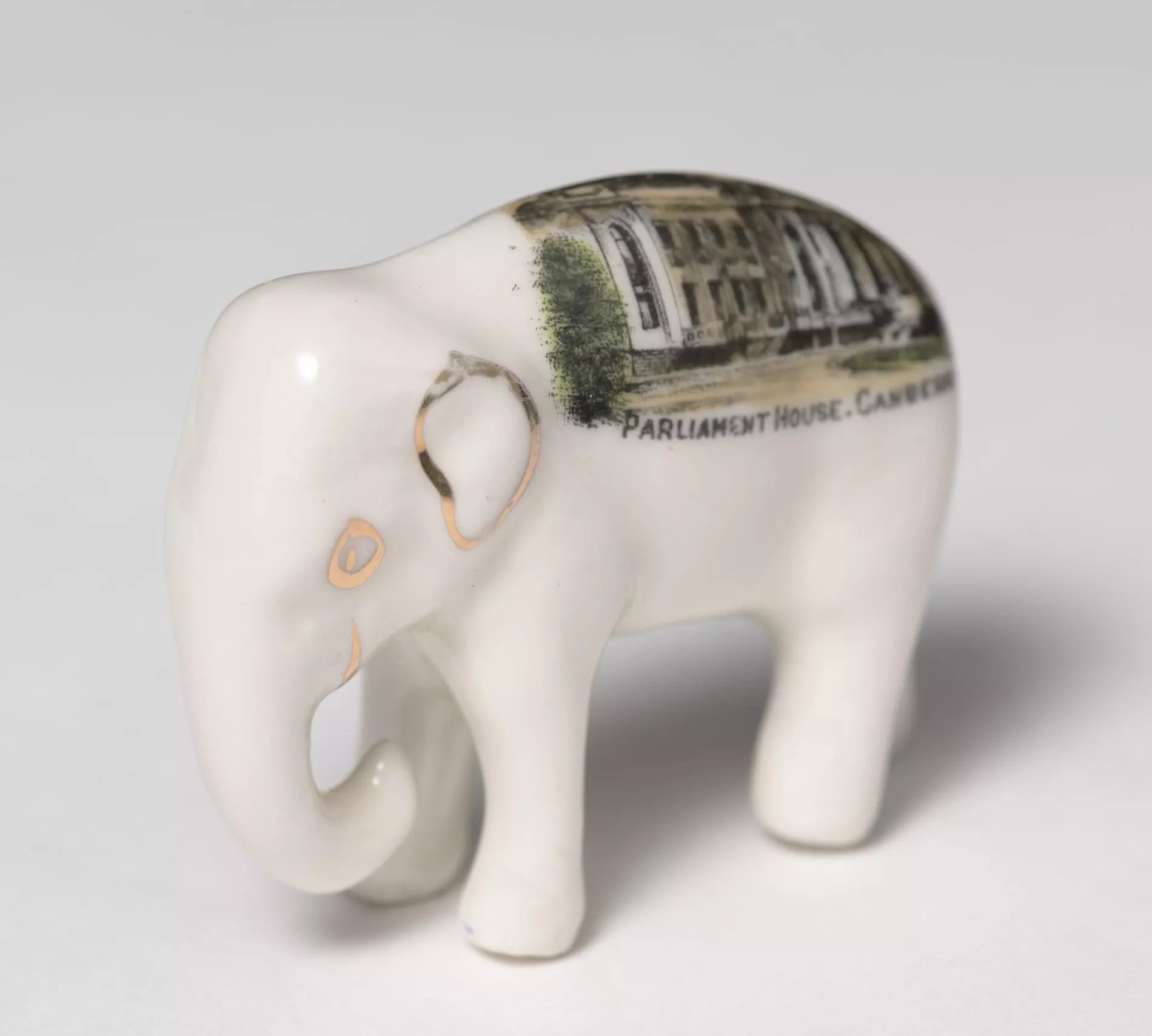 Photograph of a small, white ceramic elephant