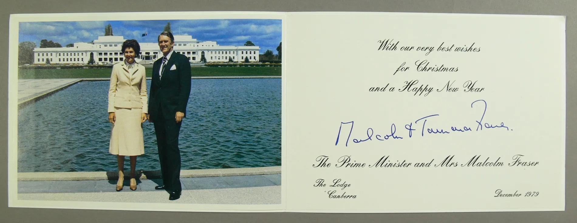 A Christmas card featuring a photo of Malcolm and Tamie Fraser, standing at the reflection pool in front of Old Parliament House.