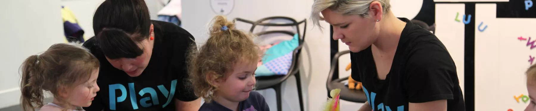 Two children playing with two PlayUP staff members