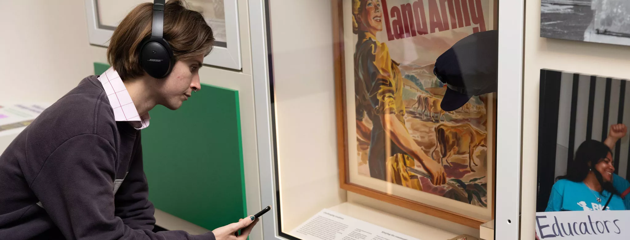 A visitor reading the information under one display