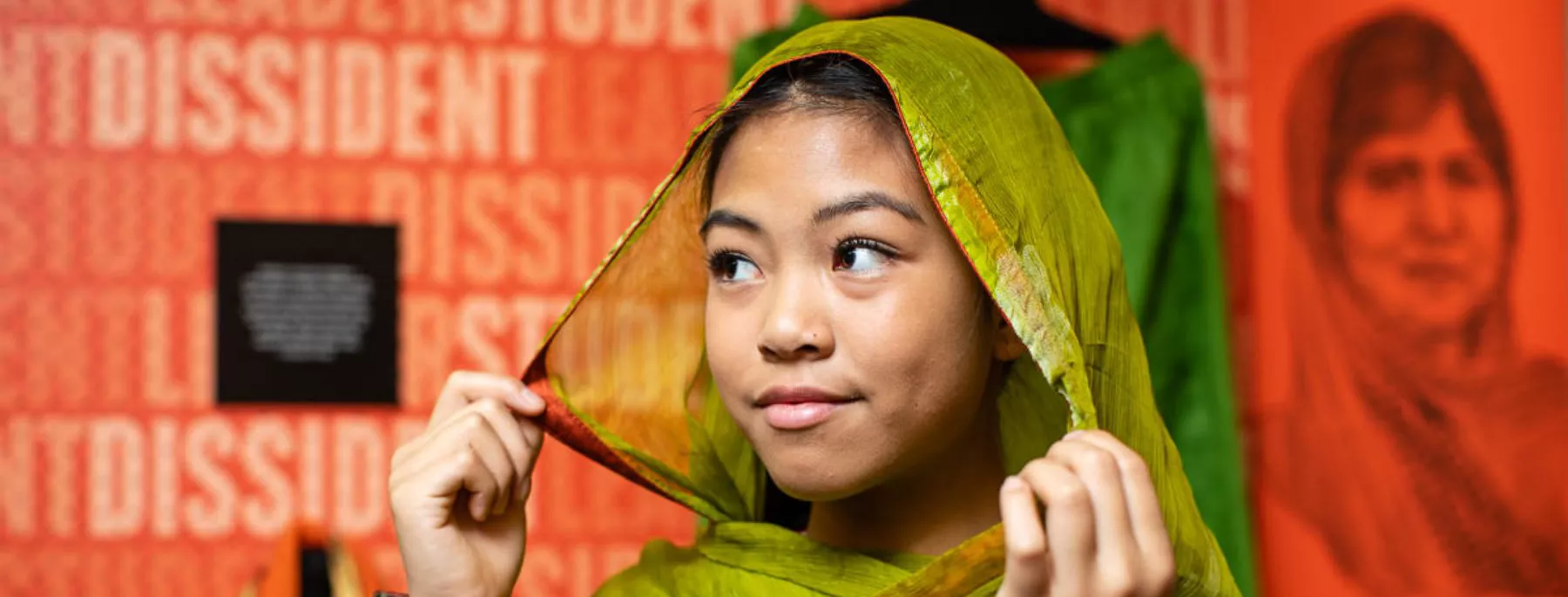 A young visitor trying on the exhibition outfits