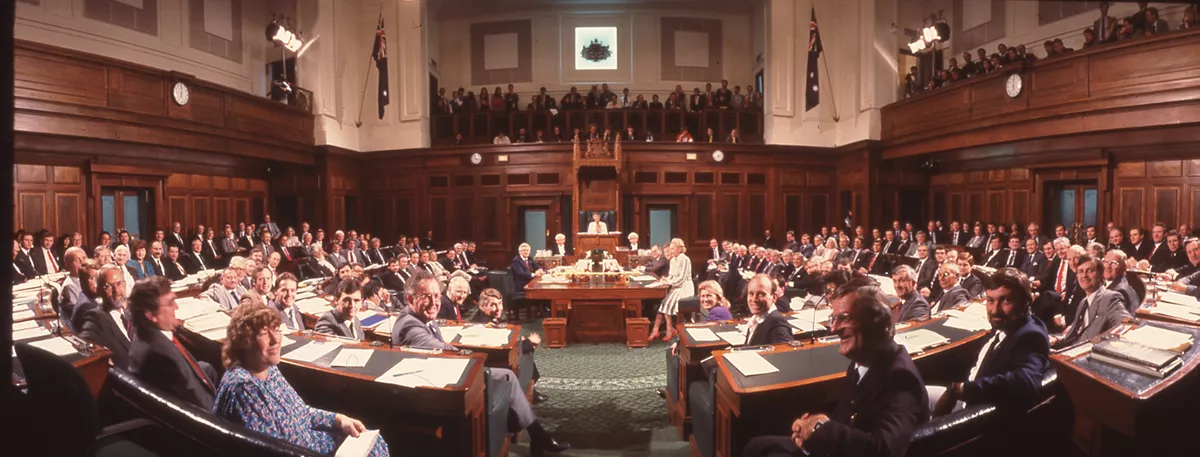 A colour photograph of the House of Representatives Chamber filled with seated politicians