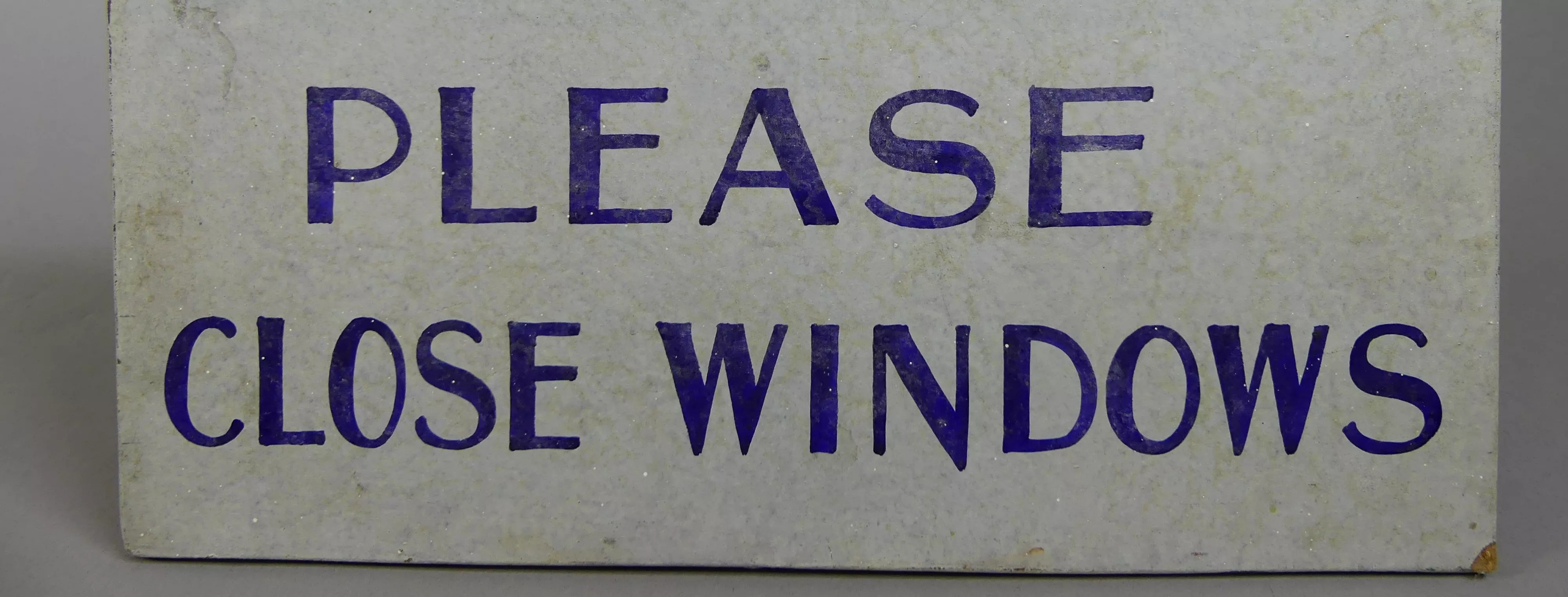 A handpainted sign that reads 'When leaving please close windows'