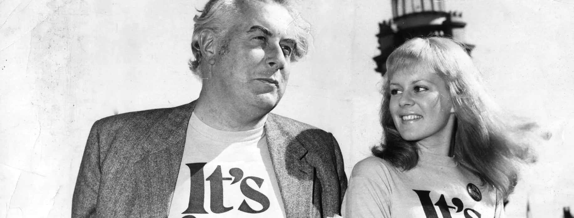 A relaxed Gough Whitlam and a smiling Patricia Amphlett posing together in t-shirts emblazoned with the words ‘It’s time’.