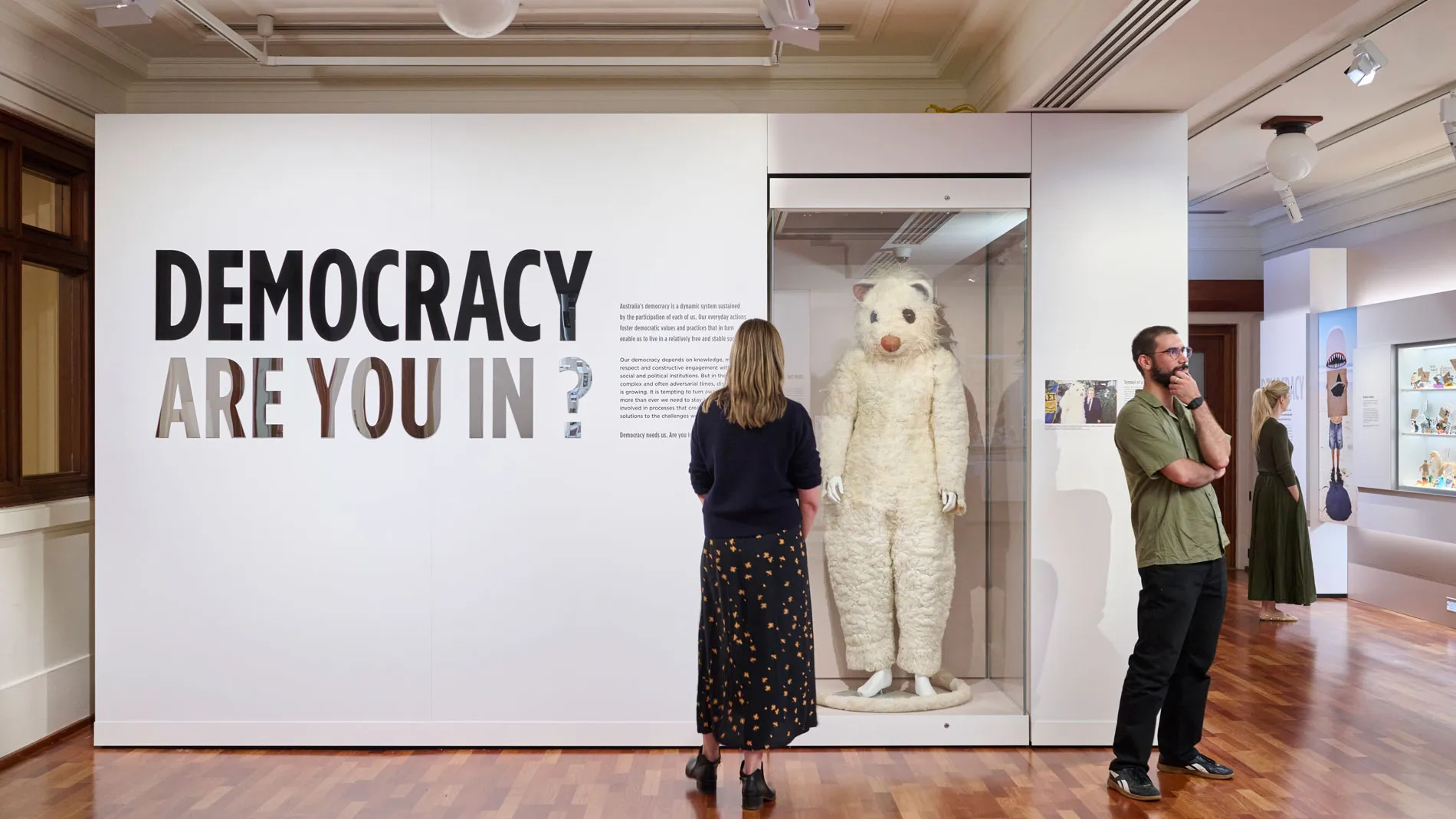People view the Democracy Are You In exhibition featuring a giant possum costume in Old Parliament House.