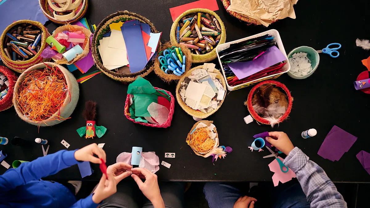 Kids and adults craft at a crafting table at Old Parliament House.