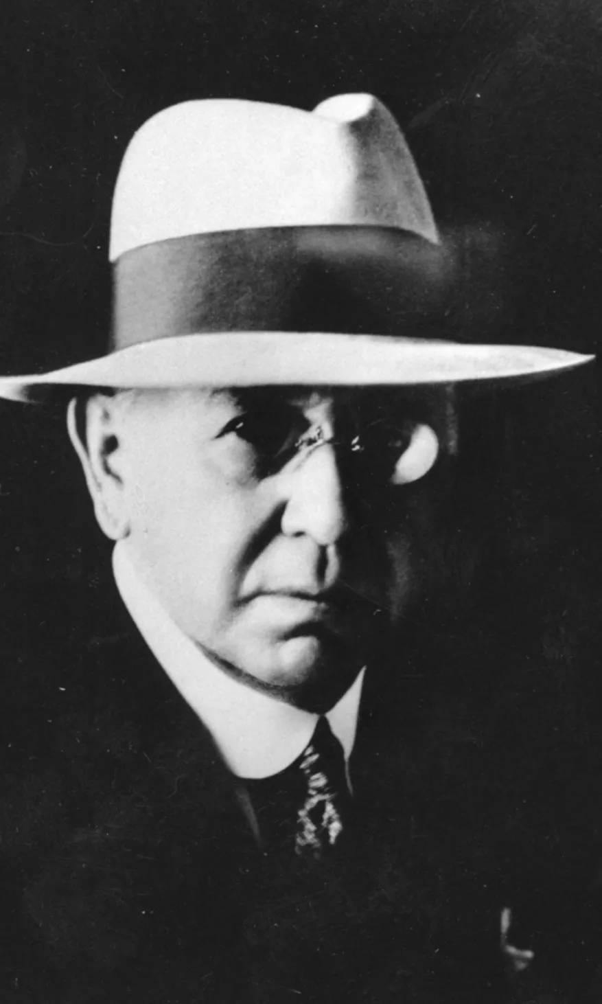 Portrait photograph of Frank Anstey, wearing a wide-brimmed hat with a thick dark band..