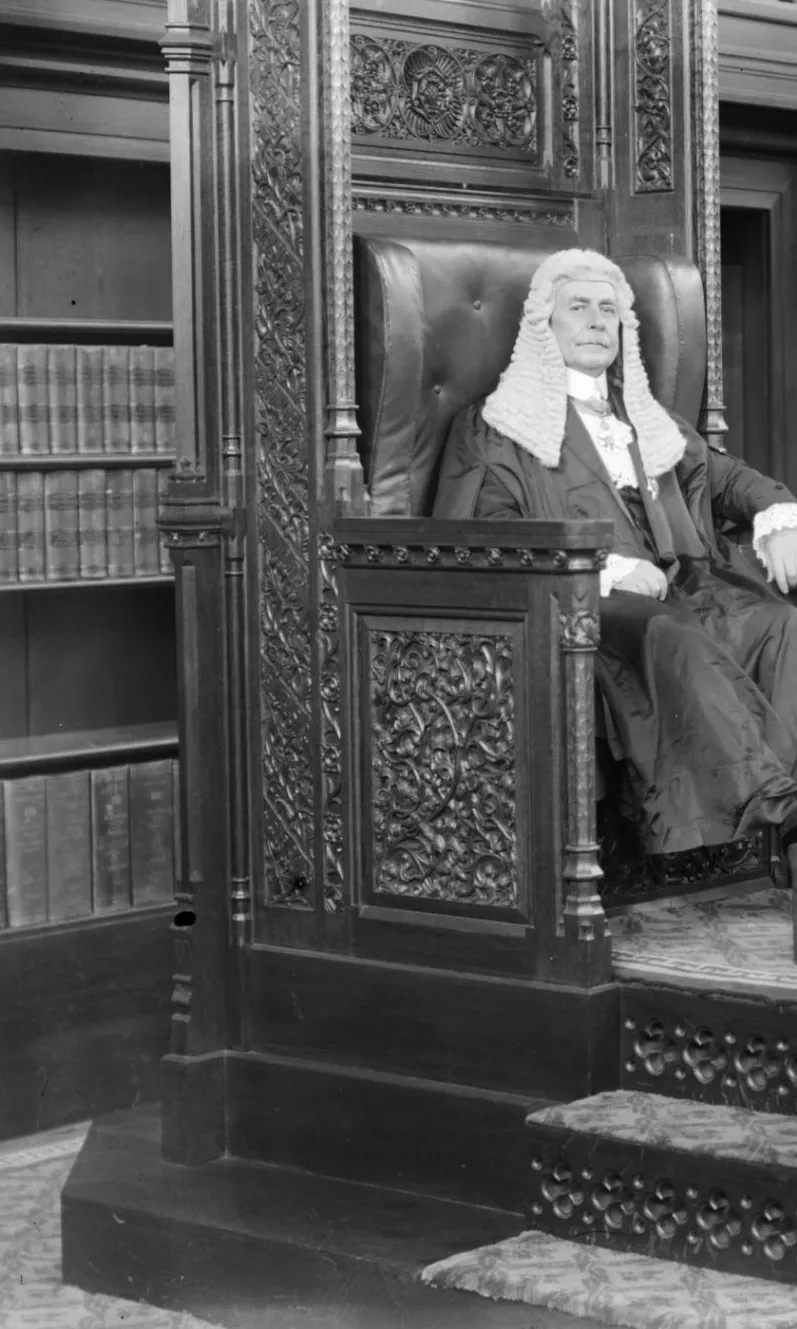 Black and white photograph of Hon Littleton Groom presiding as Speaker in the House of Representatives with the Clerk of the House in front.