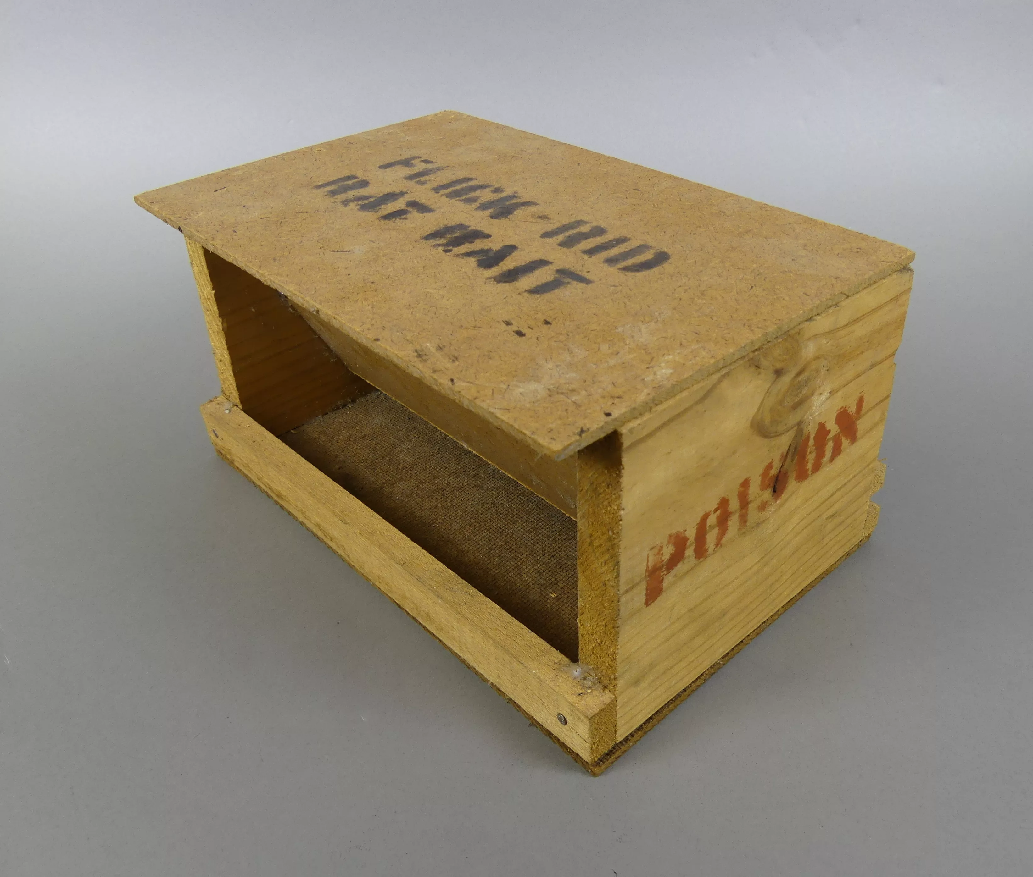 A wooden rat poison bait box, with the words 'Flick Rid Rat Bait' painted on top, and 'Poison' painted on the side.