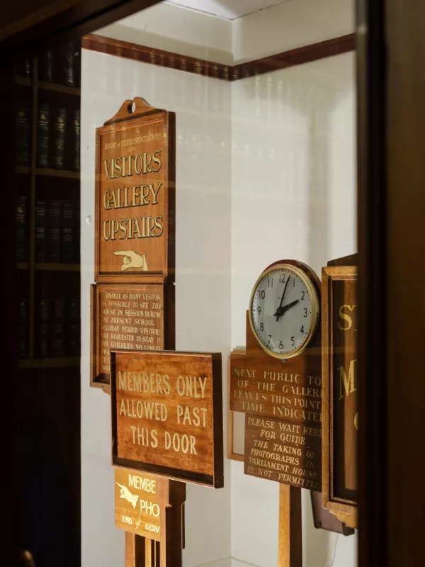 A clock and wooden signs