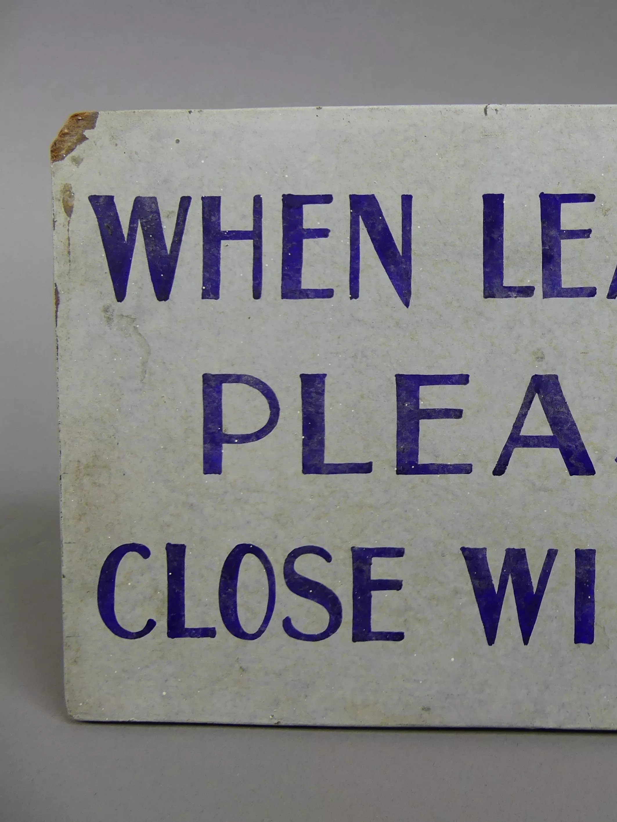 A handpainted sign that reads 'When leaving please close windows'