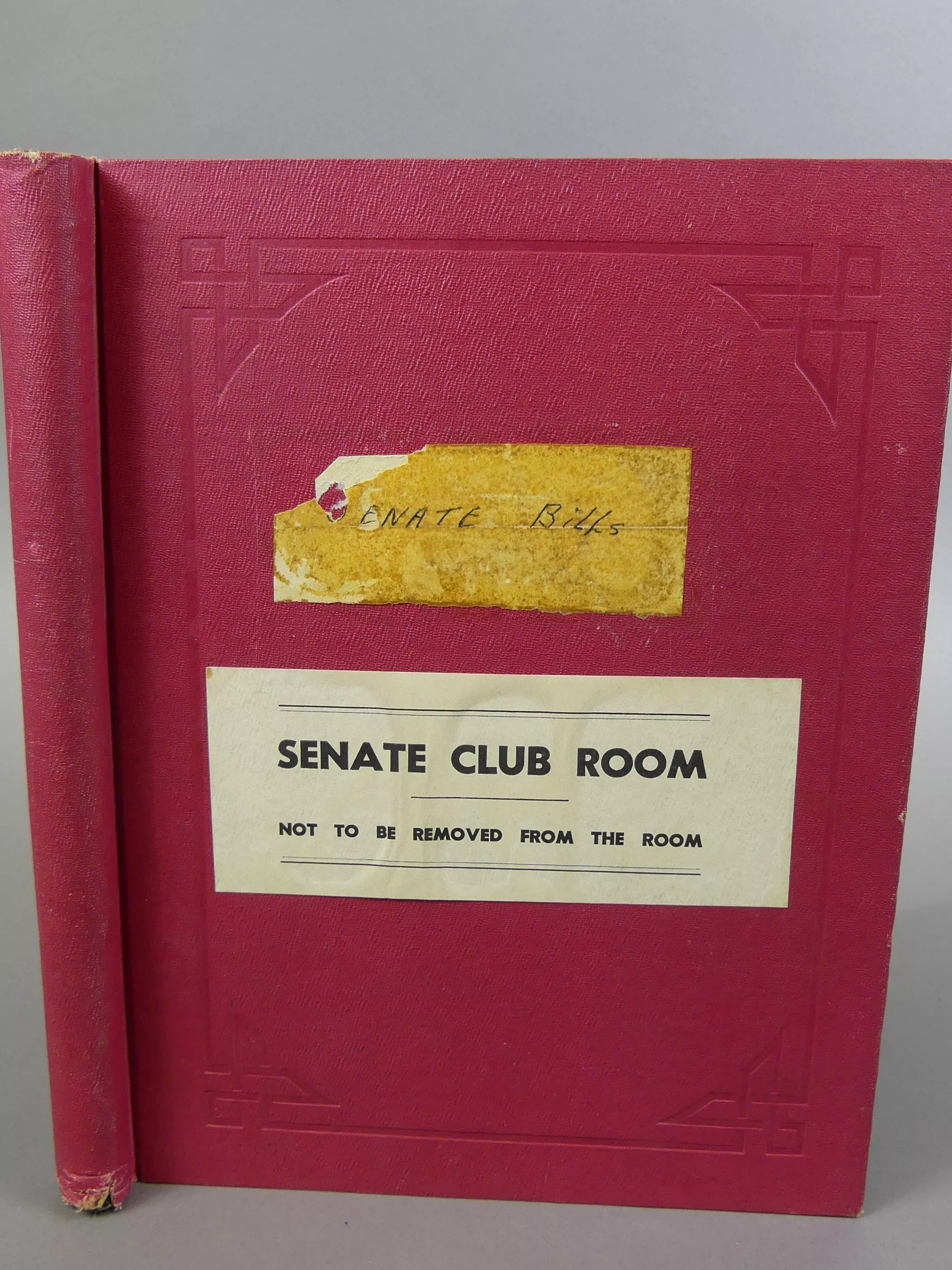 Red Senate Club Room Senate bills book with the instructions 'Not to be removed from the room' on the cover.