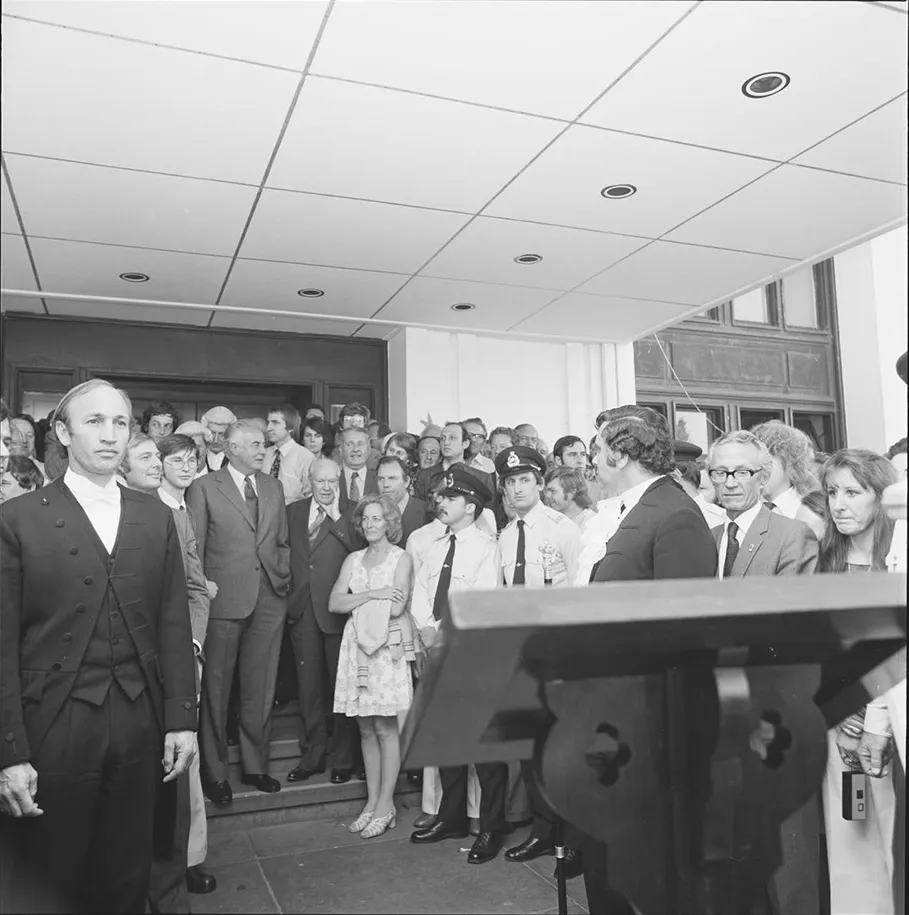 A crowd, including Prime Minister Gough Whitlam, on the steps of Parliament House. 