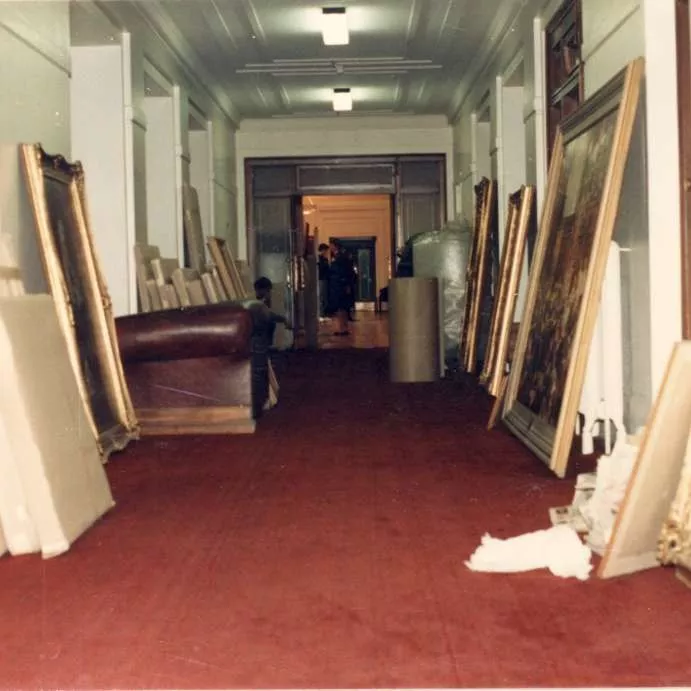 The Senate Government Lobby hallway, with large framed paintings leaning against the wall in preparation for packing and relocation.