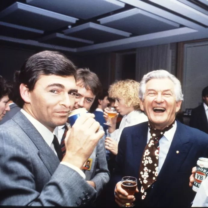 MP John Brumby (left) and Prime Minister Bob Hawke (centre) join colleagues in the Senate Committee Room for a beer and a laugh.