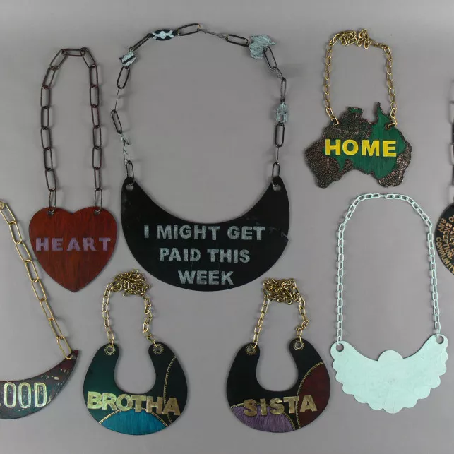 A collection of handmade breastplates, decorated with words and colours that reflect modern topics, styles and ideas.