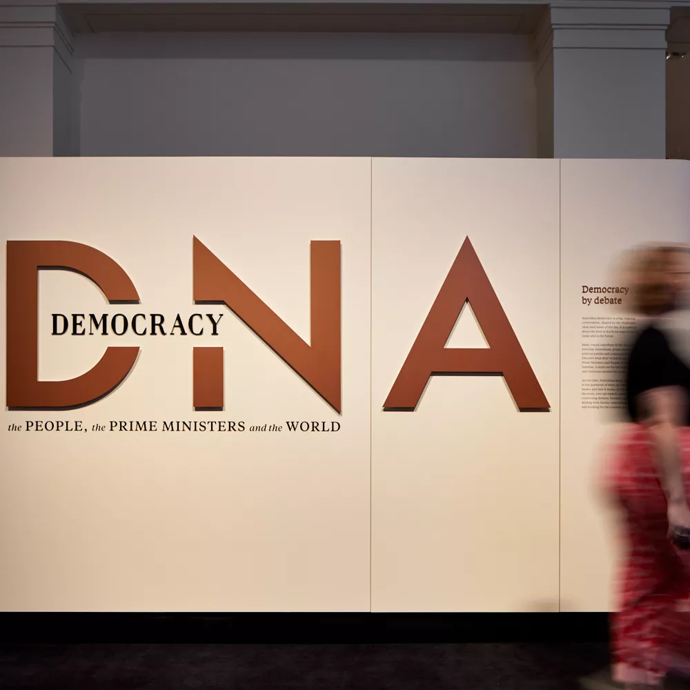 Wall that contains the exhibition's title 'Democracy DNA: the People, the Prime Ministers and the world.'