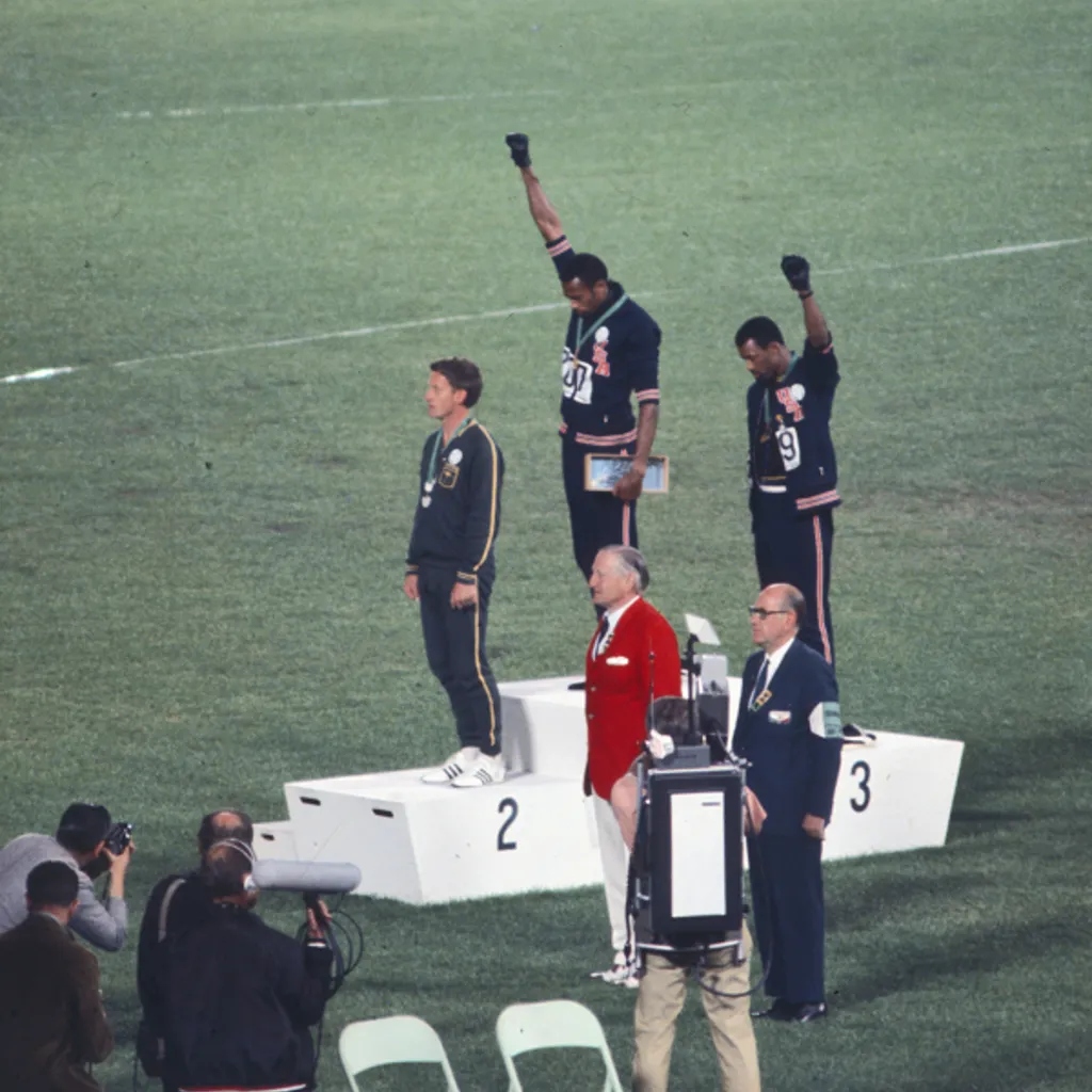 This famous photo shows Peter Norman standing silently as his two American friends give a salute for civil rights.