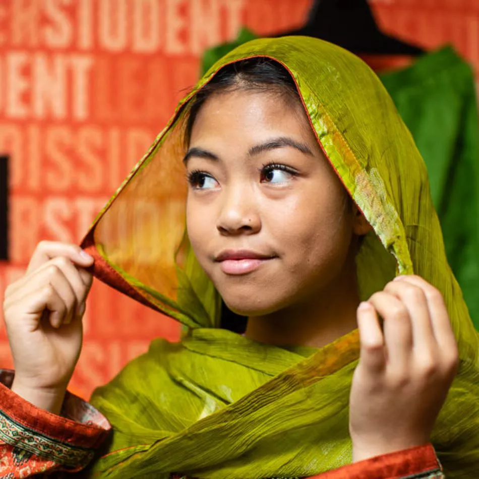 A young visitor trying on the exhibition outfits