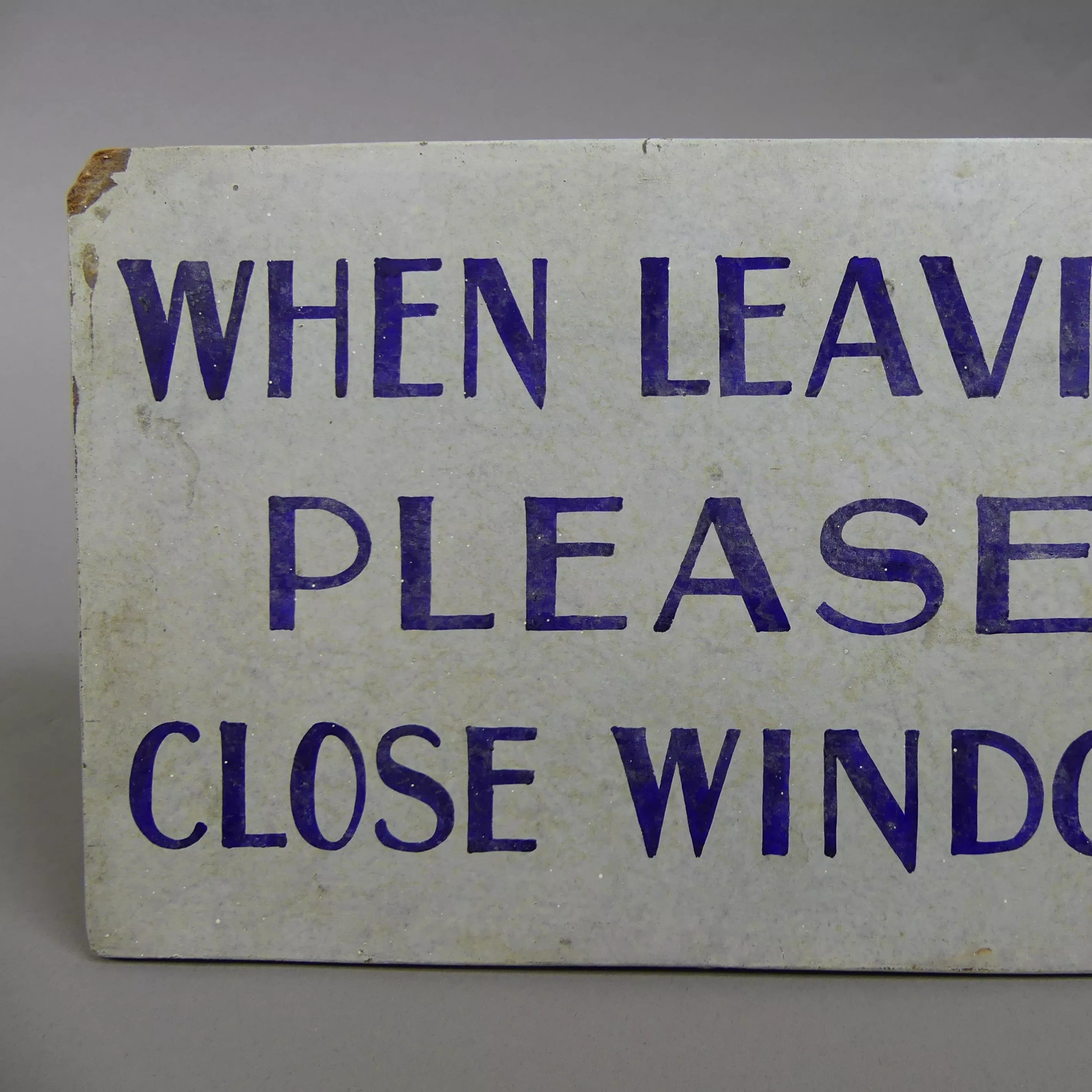 A handpainted sign that reads 'When leaving please close windows'