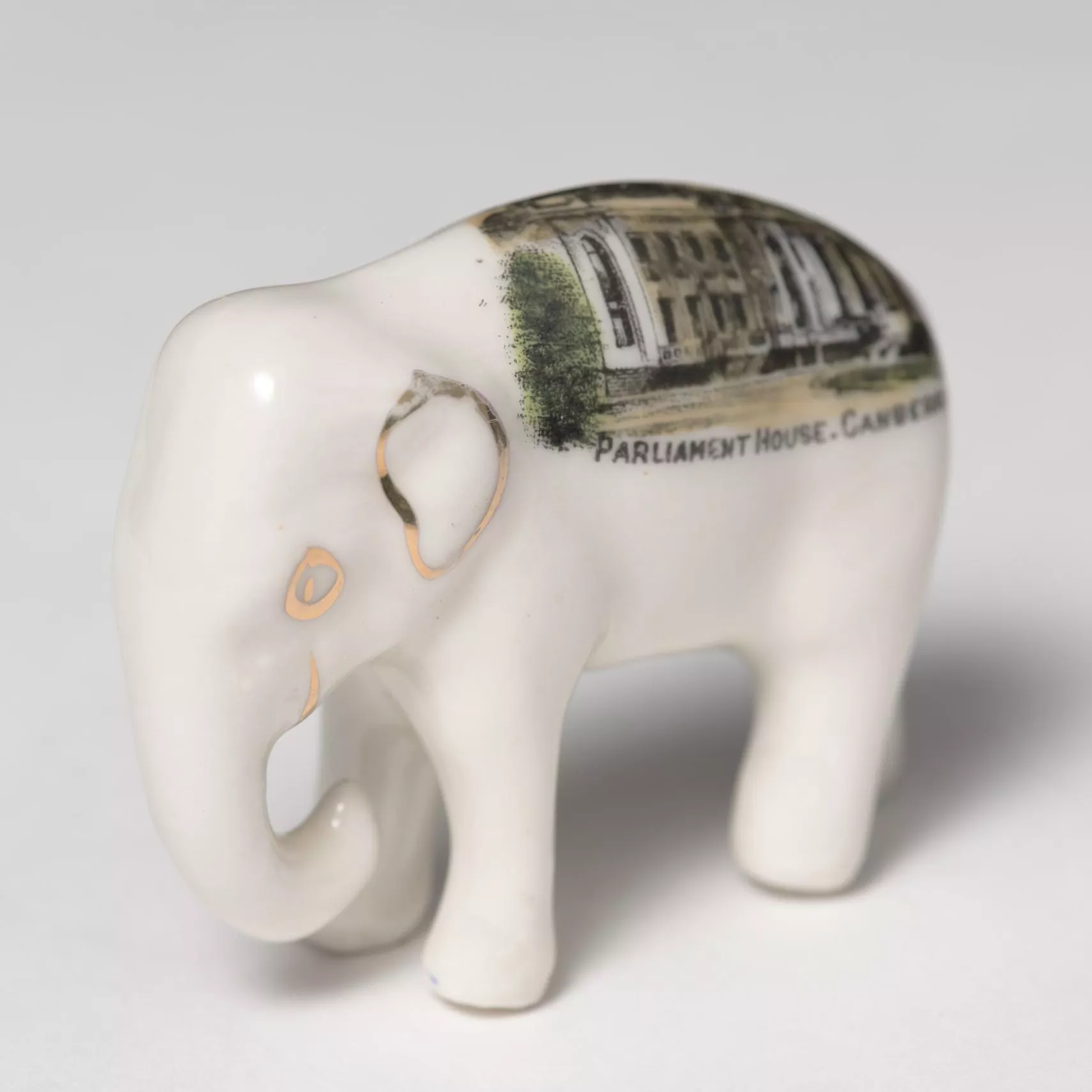 Photograph of a small, white ceramic elephant