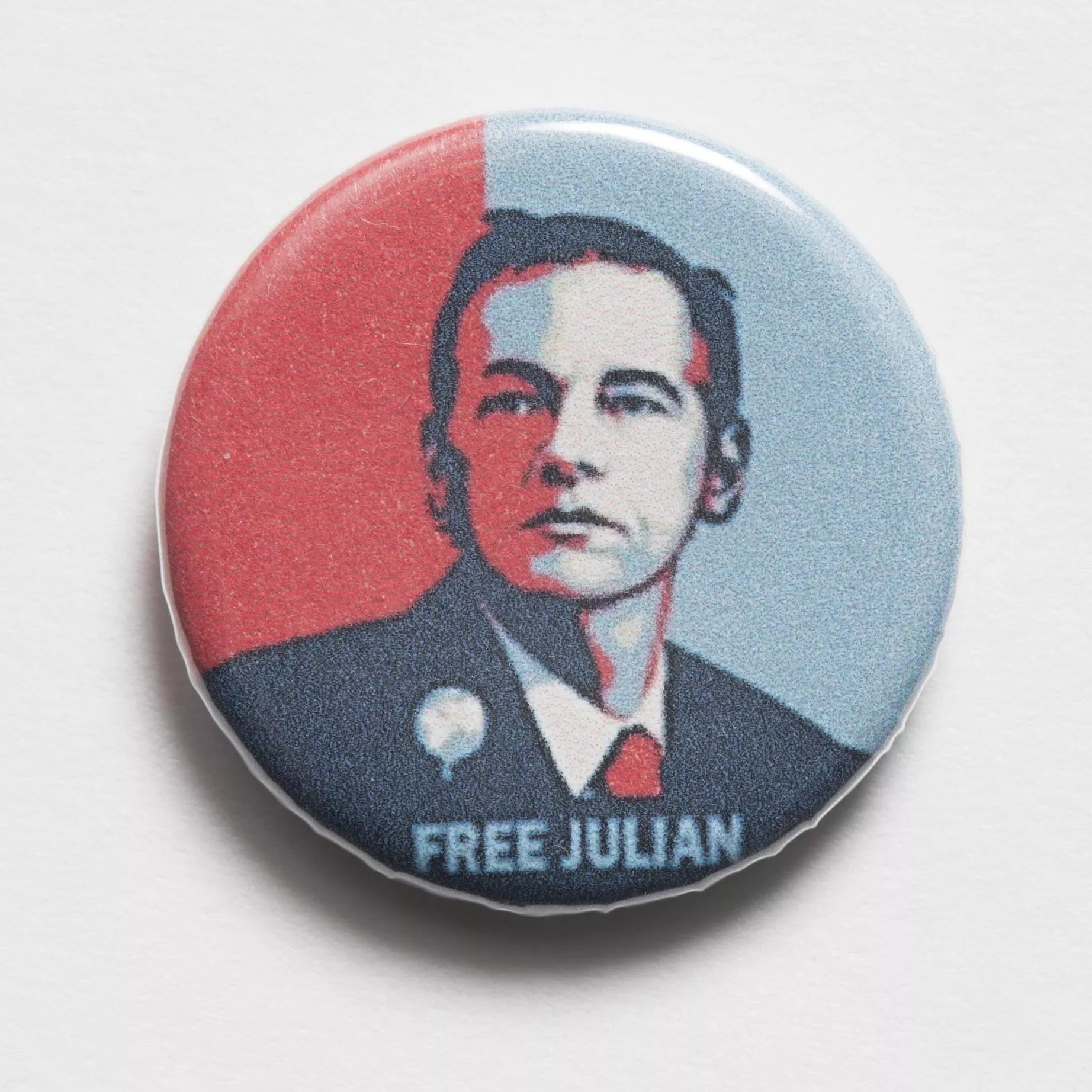 Photograph of a small badge labled "Free Julian"