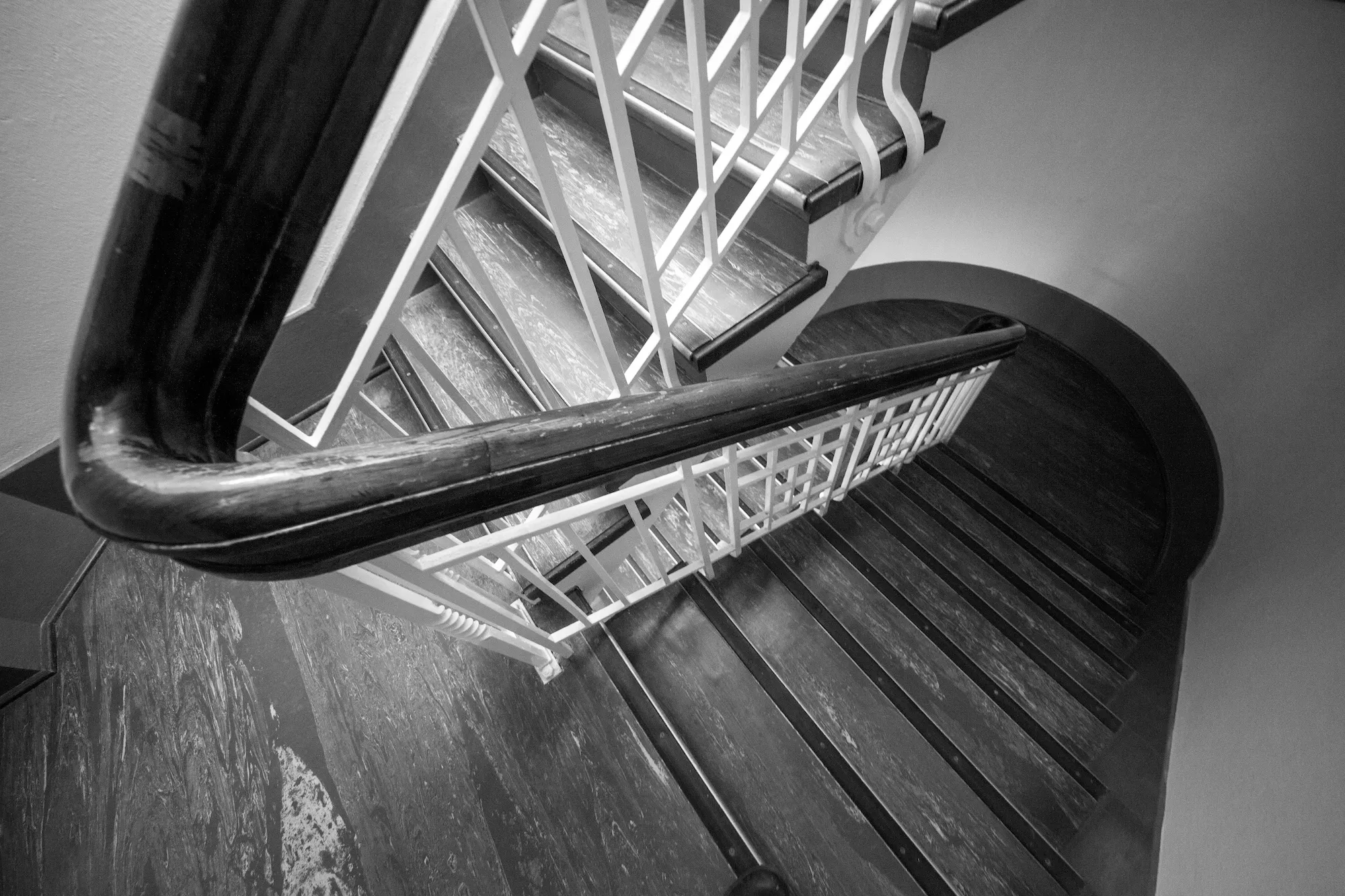 Looking down a winding staircase from above.