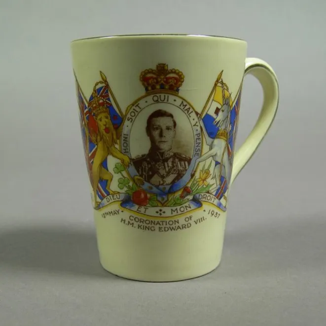 A ceramic mug featuring a portrait of Prince Edward, framed with the British coat of arms, with the words 'Coronation of H.M. King Edward VIII' and '12th May 1937'.